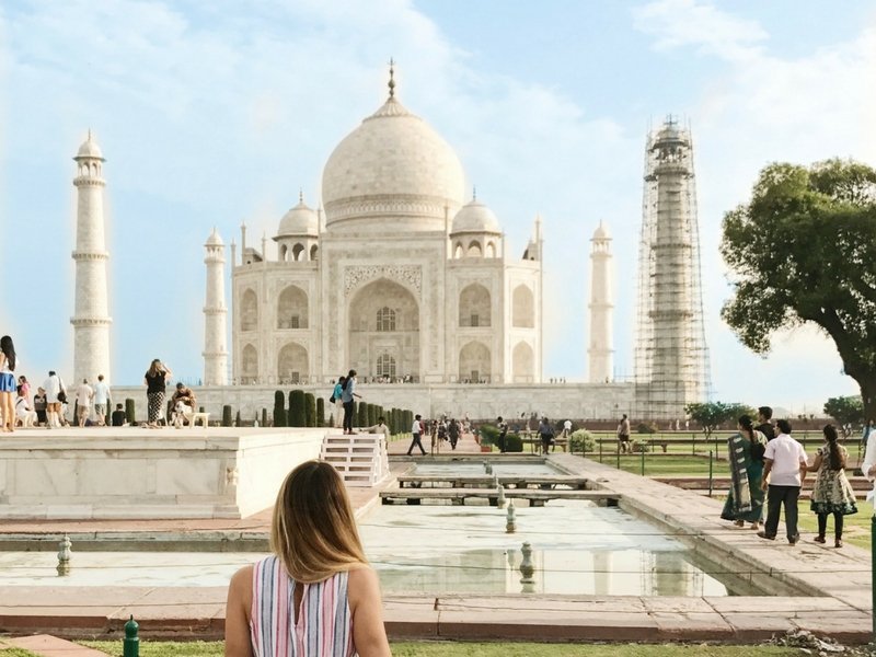 girl sitting in front of taj mahal